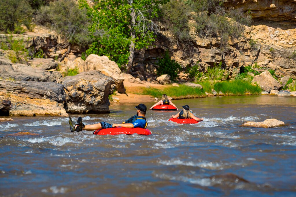 Group tubing down the river in Zion National Park, Utah, enjoying a scenic float among rocky landscapes